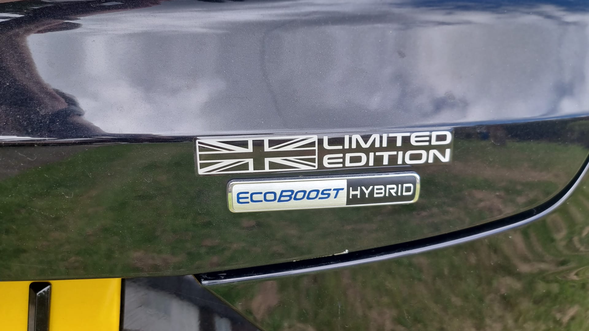 Ford car with "Limited Edition" Union Jack and "EcoBoost Hybrid" badges on the boot.